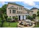 Expansive backyard with patio, fire pit, well-manicured lawn and mature landscaping at 13716 Glen Abbey Dr, Charlotte, NC 28278