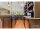 Gorgeous bar area featuring dark cabinets, granite countertops, and hardwood floors at 13716 Glen Abbey Dr, Charlotte, NC 28278