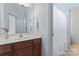 Bright bathroom featuring a single sink vanity, white walls, and a shower with a white curtain at 13716 Glen Abbey Dr, Charlotte, NC 28278