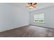 Bedroom with light blue walls, carpet, ceiling fan, and window at 13716 Glen Abbey Dr, Charlotte, NC 28278