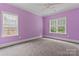 Bedroom with carpet, a ceiling fan and natural light from two windows at 13716 Glen Abbey Dr, Charlotte, NC 28278