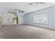 Open bonus room features carpet, ceiling fans, and natural light at 13716 Glen Abbey Dr, Charlotte, NC 28278