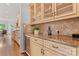 Butler's pantry with glass cabinets, wine cooler, and granite countertop at 13716 Glen Abbey Dr, Charlotte, NC 28278