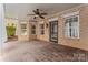 Charming covered patio with brick flooring, ceiling fan, and plenty of natural light at 13716 Glen Abbey Dr, Charlotte, NC 28278