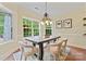 Sunlit dining room with modern chandelier and large windows at 13716 Glen Abbey Dr, Charlotte, NC 28278