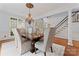 Formal dining room with a decorative chandelier, large windows, and hardwood floors at 13716 Glen Abbey Dr, Charlotte, NC 28278