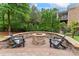 Inviting outdoor space featuring a stone fire pit and Adirondack chairs, perfect for relaxing evenings at 13716 Glen Abbey Dr, Charlotte, NC 28278