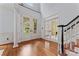 Grand foyer with hardwood floors, staircase, and double doors leading to the outside at 13716 Glen Abbey Dr, Charlotte, NC 28278