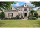 Charming brick two-story home featuring manicured landscaping and black shutters at 13716 Glen Abbey Dr, Charlotte, NC 28278