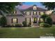 Beautiful two-story home with a brick facade, manicured lawn, and well-maintained landscaping at 13716 Glen Abbey Dr, Charlotte, NC 28278