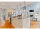 Gourmet kitchen featuring an island, stainless appliances, and a fireplace nearby at 13716 Glen Abbey Dr, Charlotte, NC 28278