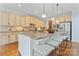 Gourmet kitchen with large island, stainless appliances, and a breakfast bar at 13716 Glen Abbey Dr, Charlotte, NC 28278