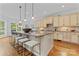 Gourmet kitchen island with seating, pendant lights, and stainless steel appliances at 13716 Glen Abbey Dr, Charlotte, NC 28278