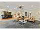 Open concept living room and bar with plush sofas and a contemporary design at 13716 Glen Abbey Dr, Charlotte, NC 28278