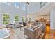 Open concept living room with views of the kitchen, high ceilings, hardwood floors, and natural light at 13716 Glen Abbey Dr, Charlotte, NC 28278