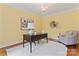 Cozy office space with a desk, chair, decorative artwork, and hardwood floors at 13716 Glen Abbey Dr, Charlotte, NC 28278