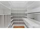 Custom walk-in closet with built-in shelving and pull-out storage at 13716 Glen Abbey Dr, Charlotte, NC 28278