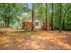 The backyard features lush trees and a brick exterior, perfect for enjoying private, peaceful outdoor area at 1401 Hillwood Ct, Charlotte, NC 28210