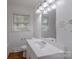 Bathroom featuring a sink, toilet, and mirror at 1401 Hillwood Ct, Charlotte, NC 28210