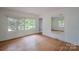 Spacious bedroom showcasing hardwood floors and natural lighting at 1401 Hillwood Ct, Charlotte, NC 28210