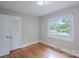 This bedroom features hardwood floors, a closet, and a window view at 1401 Hillwood Ct, Charlotte, NC 28210