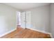 This bedroom features hardwood floors, a closet and neutral paint at 1401 Hillwood Ct, Charlotte, NC 28210