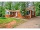 Lovely brick home with a neatly kept yard and charming details like the round window at 1401 Hillwood Ct, Charlotte, NC 28210
