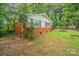 Charming brick home with white trim surrounded by lush greenery at 1401 Hillwood Ct, Charlotte, NC 28210