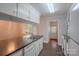 Practical kitchen with white cabinetry, dark countertops, and a view to the dining area at 1401 Hillwood Ct, Charlotte, NC 28210