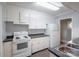 Functional kitchen with white cabinets, laminate countertops, and essential appliances at 1401 Hillwood Ct, Charlotte, NC 28210