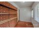 Bright sunroom featuring terra cotta tile floors, access to laundry, and custom brick shelving at 1401 Hillwood Ct, Charlotte, NC 28210
