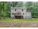 Back exterior of a white siding home with a wood deck and green grass surroundings at 14027 Hackamore Dr, Matthews, NC 28105