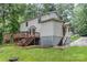 Two-story home featuring a wood deck, siding, brick foundation, and wooded surroundings at 14027 Hackamore Dr, Matthews, NC 28105