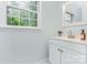 Cozy bathroom featuring a sleek white vanity and a bright window at 14027 Hackamore Dr, Matthews, NC 28105