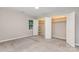 Neutral bedroom with double closet open to reveal storage, plus a bright window and carpet floor at 14027 Hackamore Dr, Matthews, NC 28105