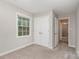 This neutral bedroom features a double closet and bright window, plus an open doorway to hallway at 14027 Hackamore Dr, Matthews, NC 28105