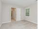 Bedroom with neutral walls, carpet, and a door to the ensuite bathroom at 14027 Hackamore Dr, Matthews, NC 28105
