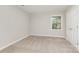 Neutral bedroom with a window providing natural light and a closet at 14027 Hackamore Dr, Matthews, NC 28105