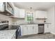 Well-lit kitchen with stainless steel appliances, granite counters, and white cabinetry at 14027 Hackamore Dr, Matthews, NC 28105
