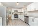 Modern kitchen featuring stainless steel appliances, granite countertops, and white cabinets at 14027 Hackamore Dr, Matthews, NC 28105