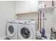 New laundry room features a newer washer, dryer, and storage shelving at 14027 Hackamore Dr, Matthews, NC 28105