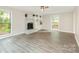 Spacious living room with a decorative fireplace and large windows at 14027 Hackamore Dr, Matthews, NC 28105