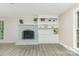 Comfortable living room featuring a painted fireplace, built-in storage, and recessed lighting at 14027 Hackamore Dr, Matthews, NC 28105