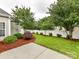 Well maintained backyard featuring lush grass, landscaping, mulch and a white fence at 147 Wren Hill Dr, Mooresville, NC 28115