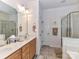 Bright bathroom featuring double sinks, framed mirrors, and tiled flooring at 147 Wren Hill Dr, Mooresville, NC 28115