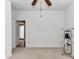 Open view of an empty bedroom with a ceiling fan and neutral carpeting at 147 Wren Hill Dr, Mooresville, NC 28115