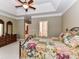 A roomy bedroom with neutral walls and tray ceilings offering a peek into the luxurious ensuite at 147 Wren Hill Dr, Mooresville, NC 28115