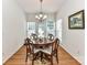 A charming dining area bathed in natural light, showcasing a round wooden table and hardwood flooring at 147 Wren Hill Dr, Mooresville, NC 28115
