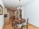 A dining area features a round table with hardwood floors and seamlessly connects to the kitchen and living room at 147 Wren Hill Dr, Mooresville, NC 28115