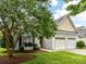 Charming home featuring a two-car garage and a well-manicured lawn with beautiful landscaping at 147 Wren Hill Dr, Mooresville, NC 28115